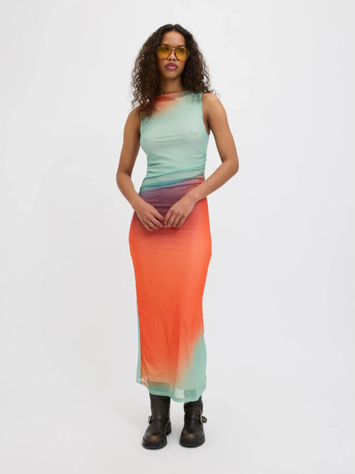 Trendy body-skimming sleeveless maxi dress in coral and mint watercolor fade for vacation styling.