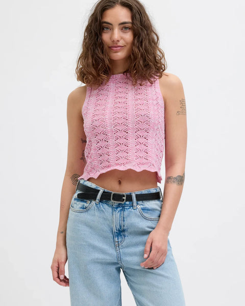 Contemporary sleeveless pointelle knit tank in pastel pink with trendy Y2K-inspired fashion vibe.