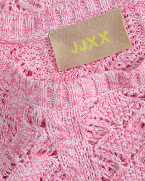 Ultra close up of contemporary boho crop knit with delicate crochet texture and fashion-forward summer styling.