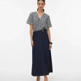 Women's boutique leaf print top with short sleeves, flattering drape, and breathable fabric perfect for warm-weather dressing.