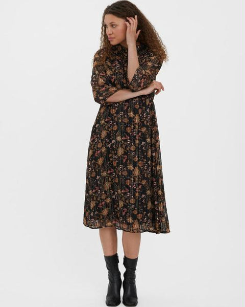 Boho floral midi dress with long sleeves and feminine tiered skirt styling.