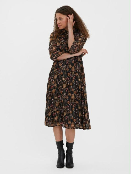 Boho floral midi dress with long sleeves and feminine tiered skirt styling.