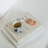 KKNEKKI Mix Orange Pistachio Glitter, big, bold and colorful. A cup of tea and two books, with an orange and multi-colored Kknekki hair ties.