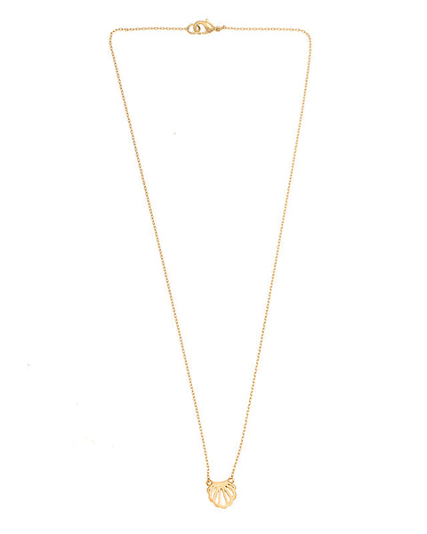 Gold seashell charm necklace with understated luxury and trendy layered necklace look.