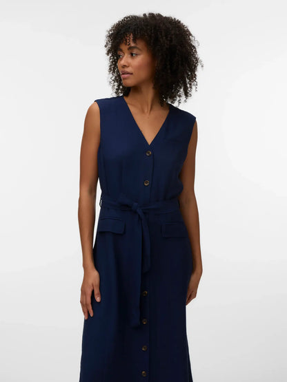 Minimalist navy blue midi dress designed with flattering tailoring, practical pockets, and breathable fabric for all-day comfort.