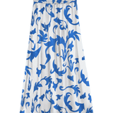 Women's white and cobalt blue botanical print midi skirt with elastic waist and flowing A-line silhouette for resort vacations and summer style.