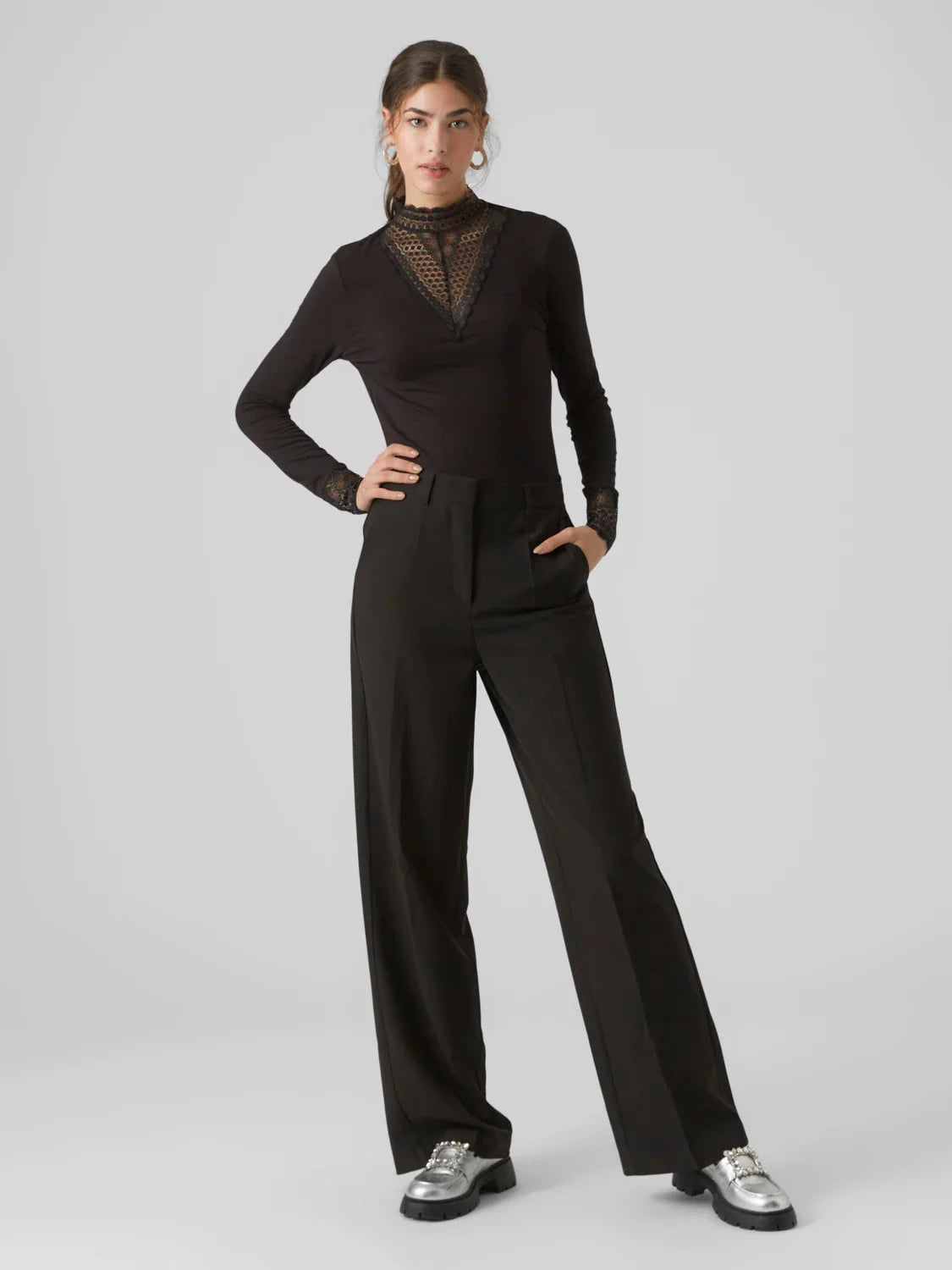 Black lace trim top with high neck and fitted silhouette for trendy date night and cocktail outfit styling.