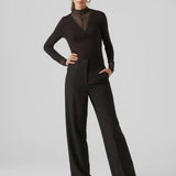 Black lace trim top with high neck and fitted silhouette for trendy date night and cocktail outfit styling.