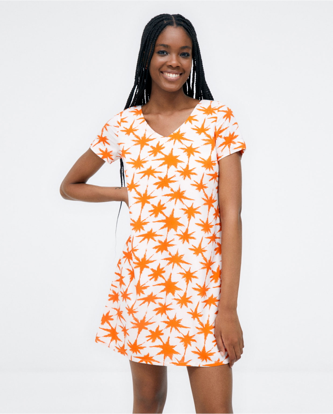 Casual summer dress featuring a bold orange starburst print and relaxed fit.