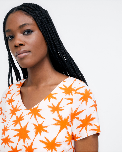 Vibrant orange print dress designed for effortless summer fashion and everyday wear.