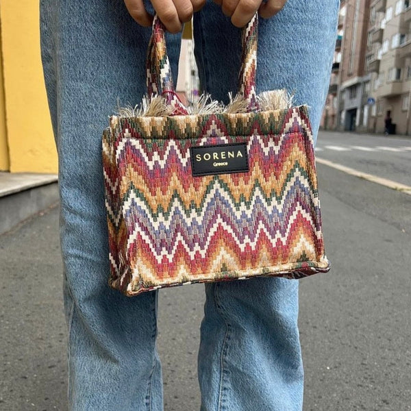 Women's woven handbag with ethnic print and trendy boutique fashion appeal.