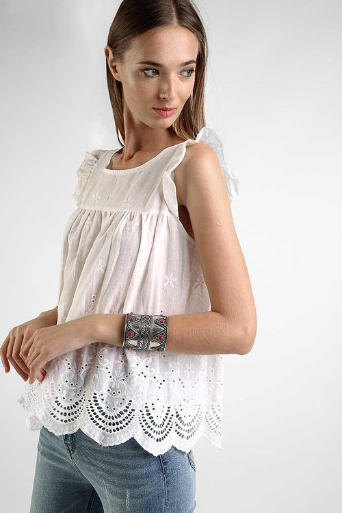 Romantic summer top in white with embroidered fabric and airy sleeveless silhouette.