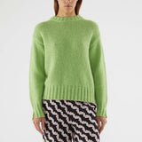 Cozy oversized crewneck sweater in light green with fluffy knit fabric and modern relaxed fit for everyday fashion.