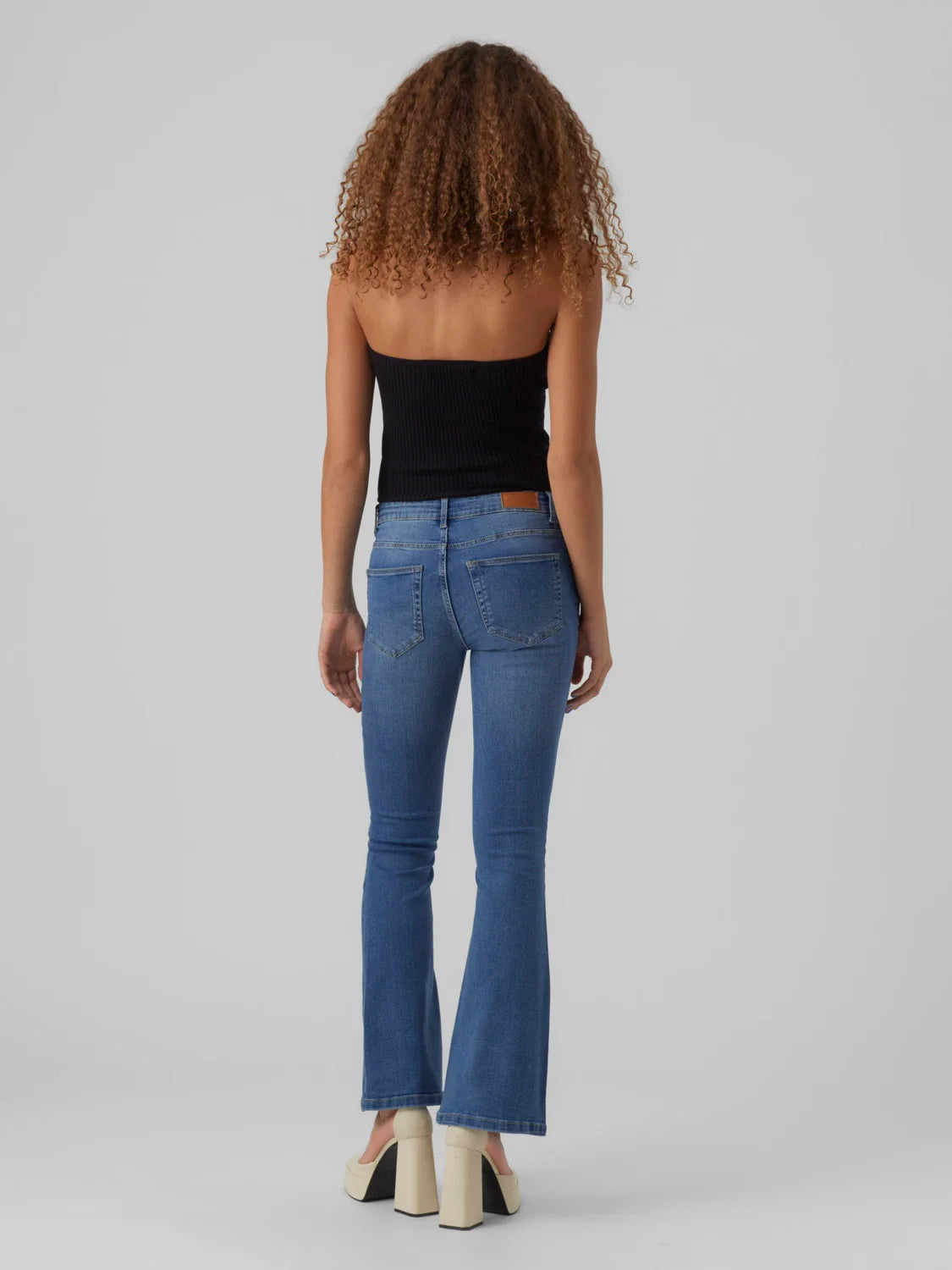 Women’s medium wash flare jeans with modern ankle-length cut and retro-inspired denim styling.