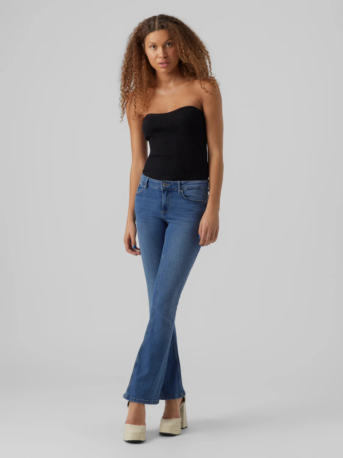 Women’s vintage-inspired flare jeans in medium blue wash with sleek fitted waist and hip design.