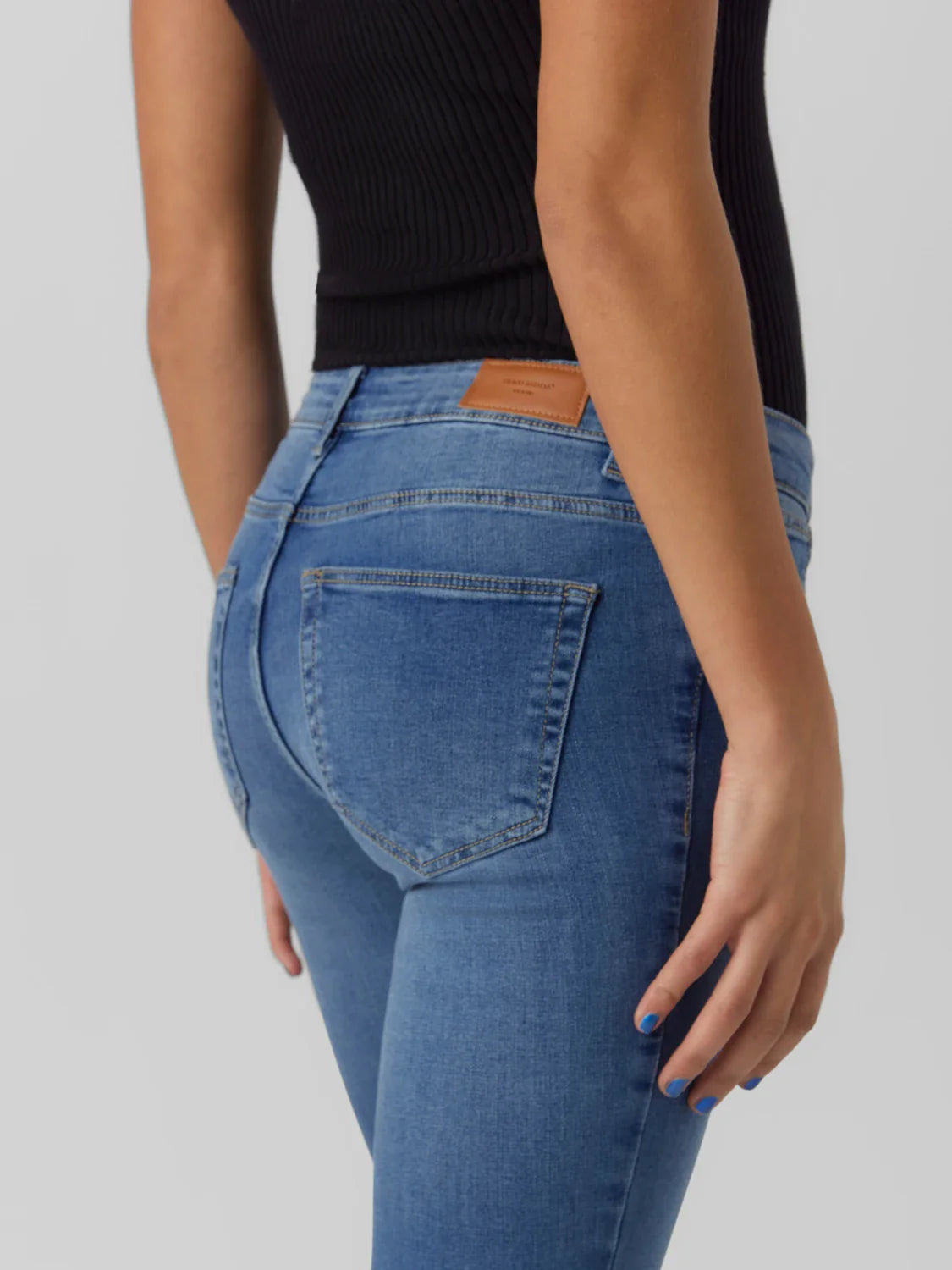Medium wash cropped jeans for women with slight flare silhouette and effortless casual chic style.