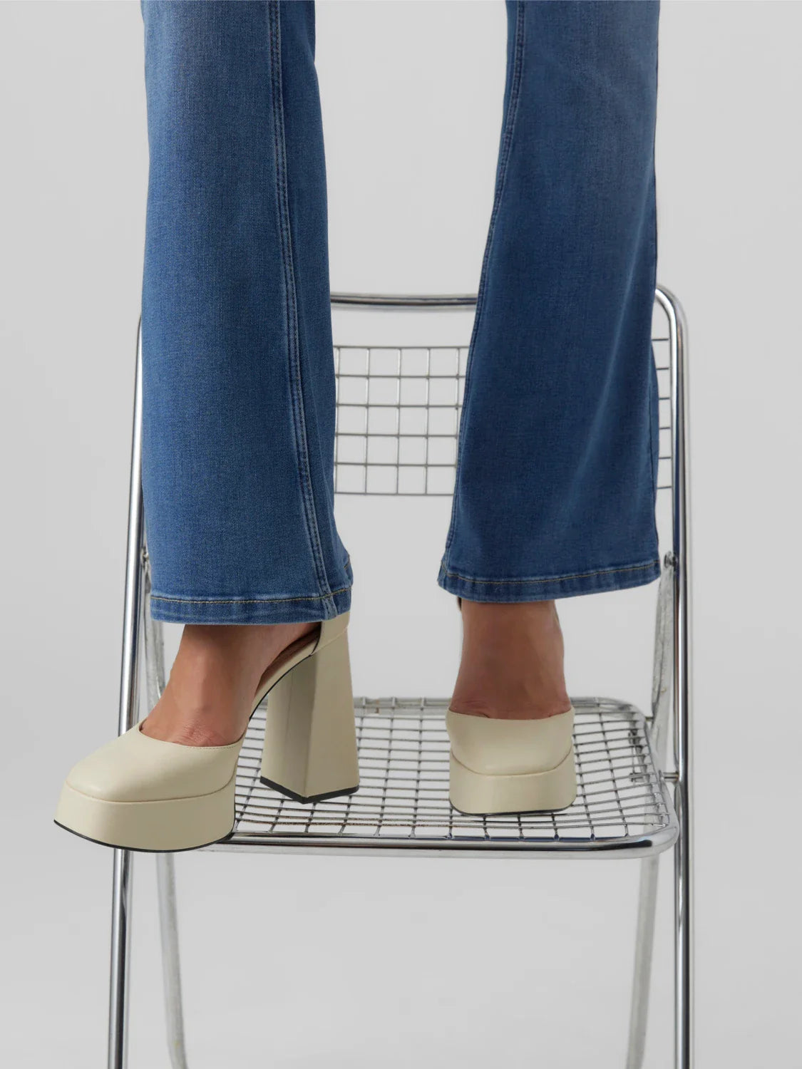 Women’s blue denim flare trousers with modern cropped length and classic everyday fashion versatility.