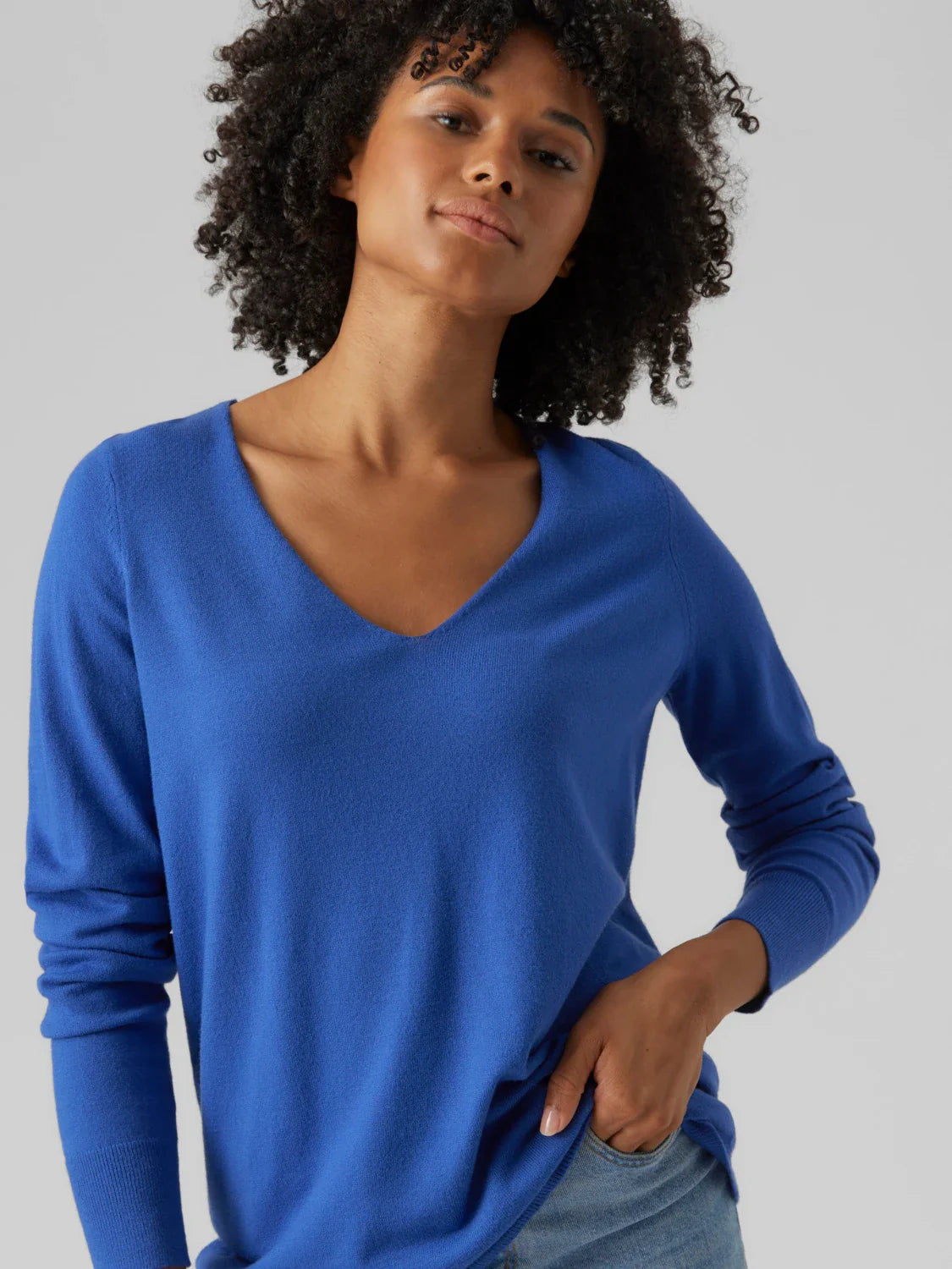 Women’s bright blue lightweight pullover with classic V-neck and modern minimalist wardrobe style.