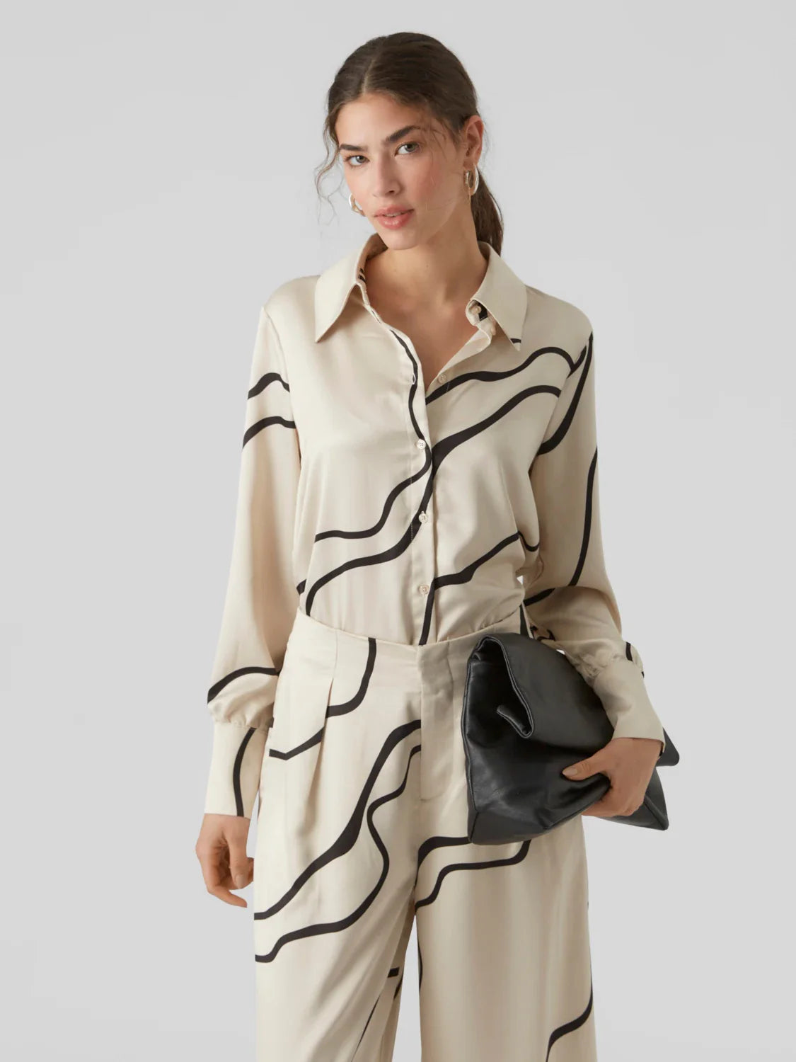 Contemporary abstract print blouse in cream and black with classic collar and relaxed fit for timeless sophisticated style.