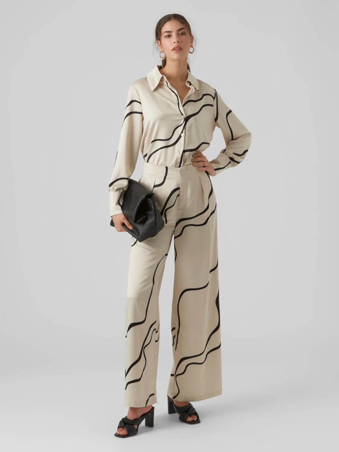 Modern cream satin blouse with bold abstract stripes and collared neckline for elevated everyday women’s fashion.