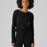 Women’s minimalist black textured blouse with elegant pleats and modern effortless chic styling.