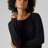 Women’s black pleated long sleeve top with elegant draped texture and sophisticated minimalist evening style.