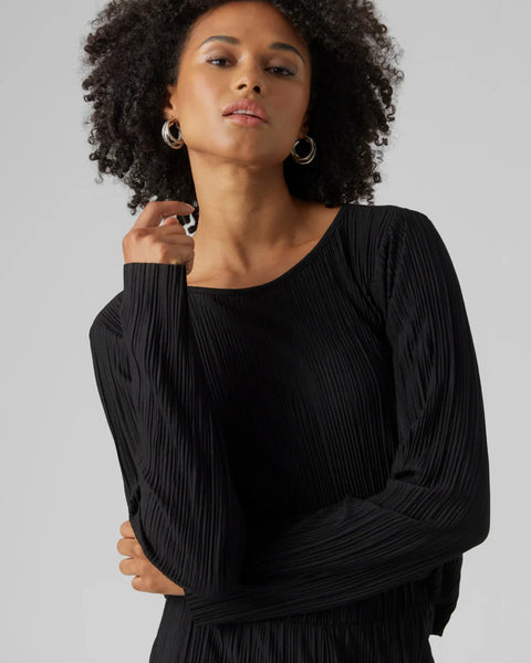 Women’s black pleated long sleeve top with elegant draped texture and sophisticated minimalist evening style.