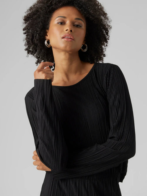 Women’s black pleated long sleeve top with elegant draped texture and sophisticated minimalist evening style.