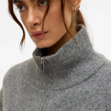 Women’s gray knitted vest with front zipper, high neckline, and relaxed silhouette for stylish everyday layering.
