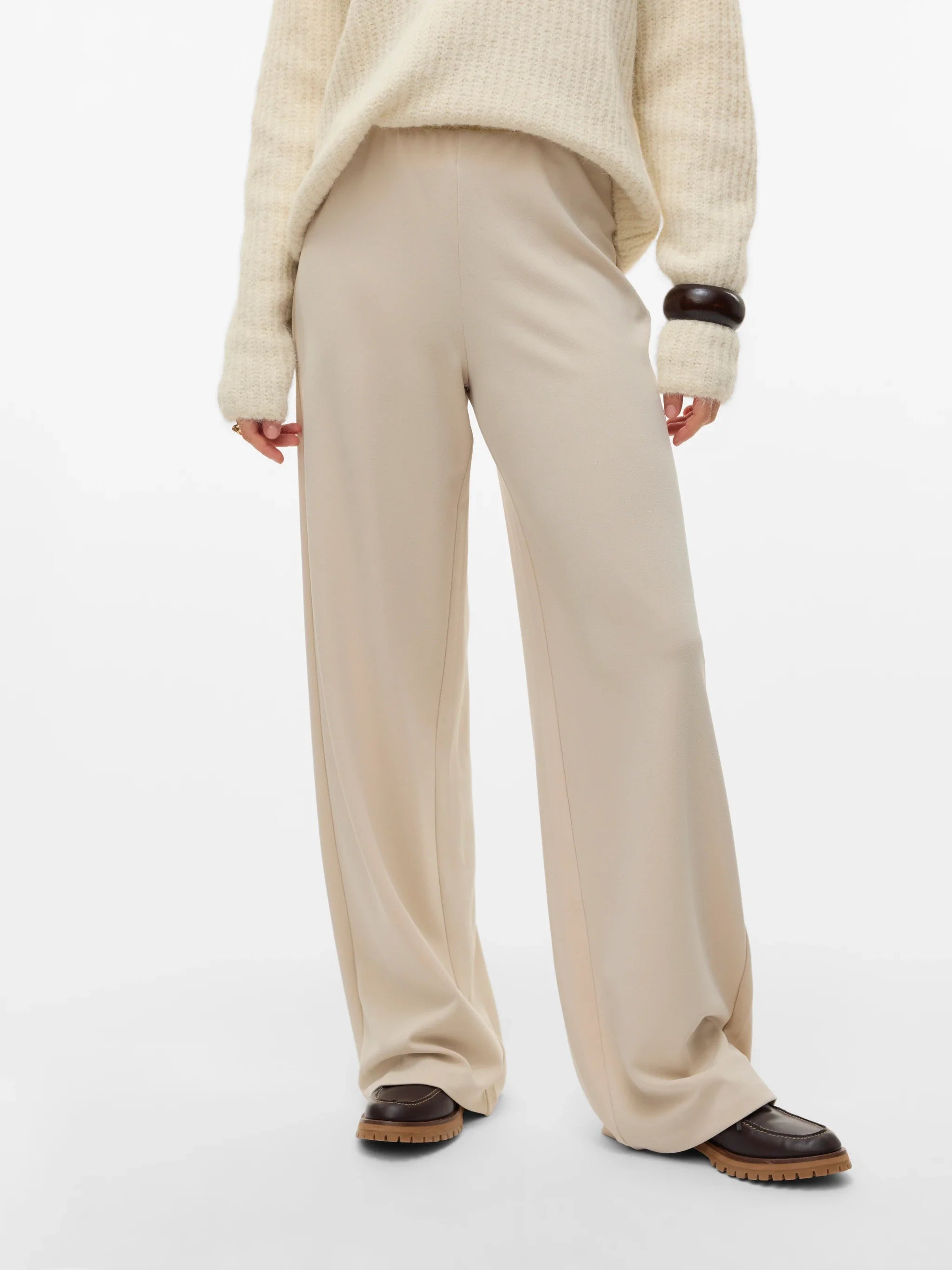 Cream wide-leg trousers for women with a high-rise waist and fluid relaxed fit for smart casual outfits.