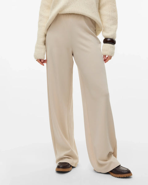 Cream wide-leg trousers for women with a high-rise waist and fluid relaxed fit for smart casual outfits.