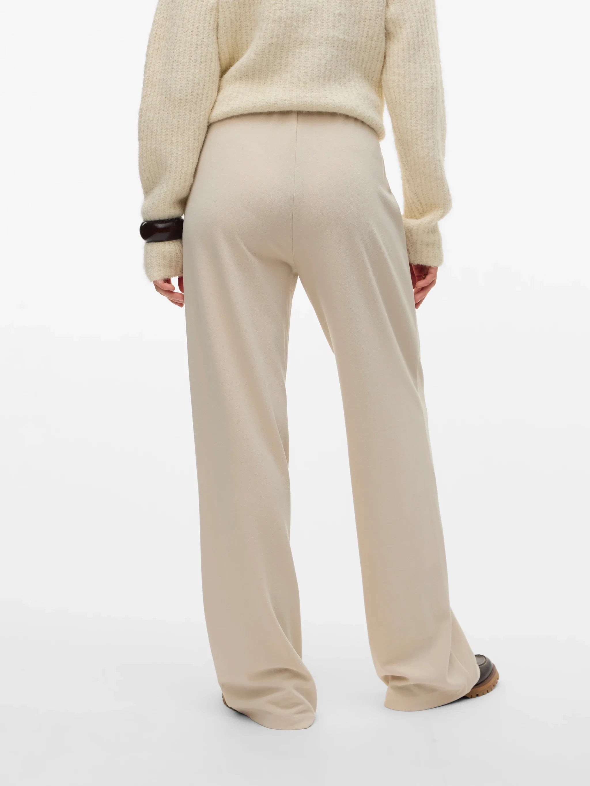 Boutique women's cream wide-leg trousers with a sophisticated high-rise design for minimalist and contemporary wardrobes.
