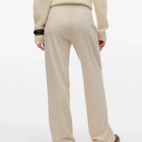 Boutique women's cream wide-leg trousers with a sophisticated high-rise design for minimalist and contemporary wardrobes.