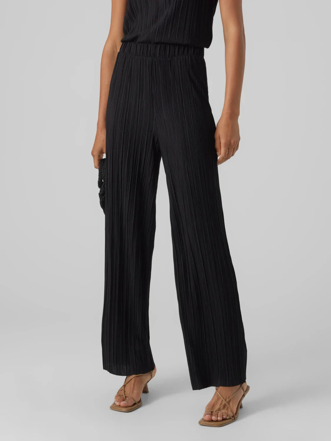 Black flowy wide leg pants for women with pleated fabric and elevated casual chic styling.