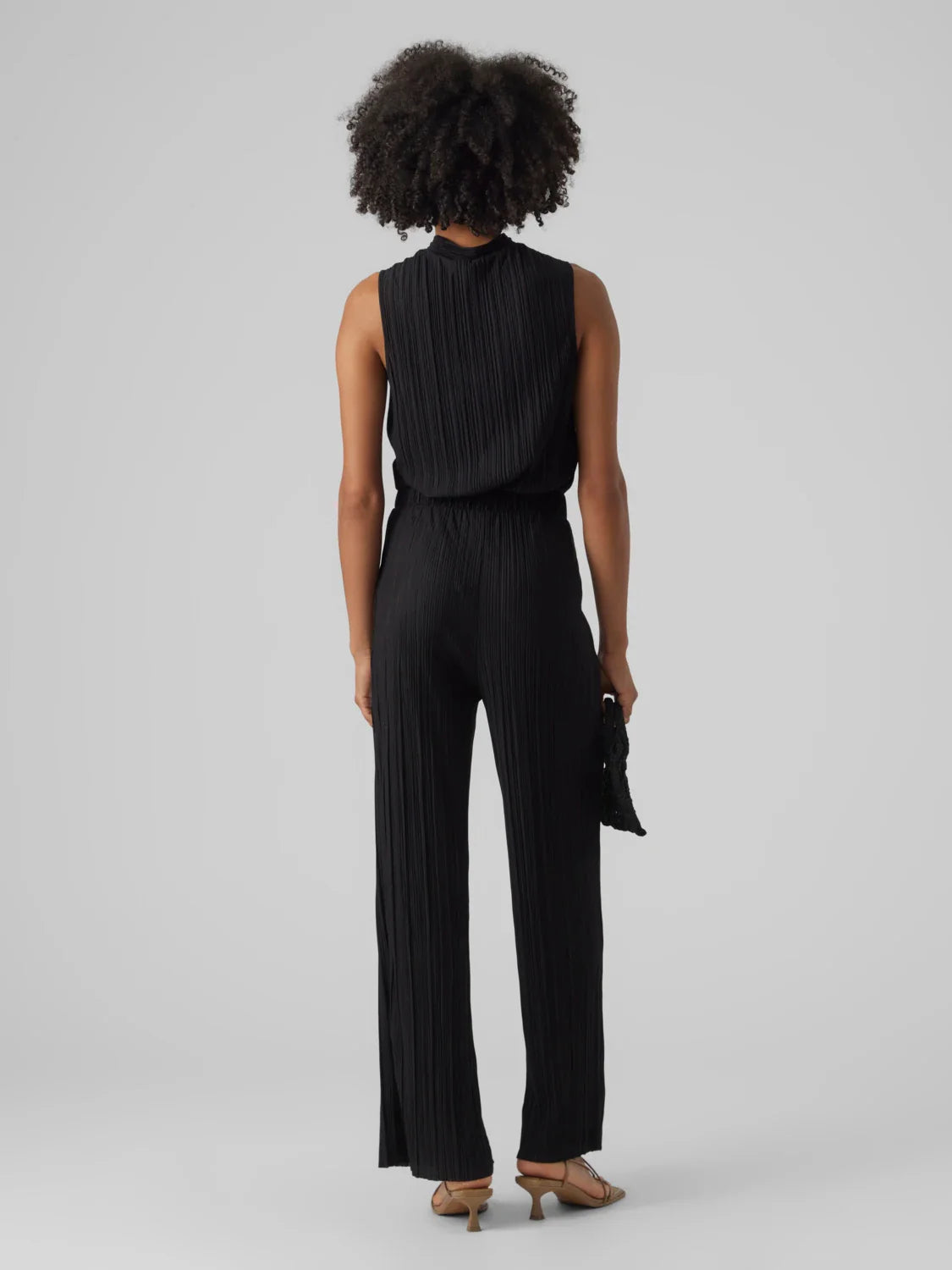 Women’s elegant black trousers with vertical pleats and wide leg cut for contemporary chic outfits.