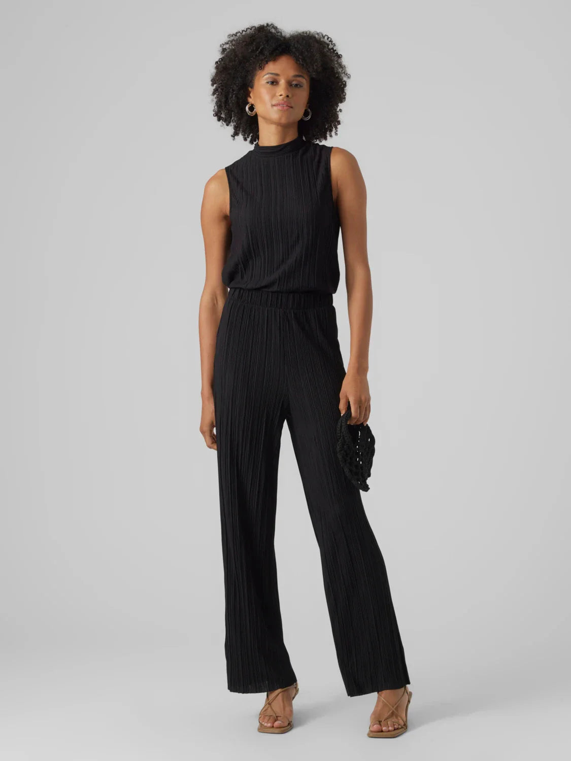 Women’s dressy black wide leg pants featuring soft pleated texture and effortless evening-ready style.