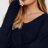 Boutique women's navy blue V-neck knit pullover with plush texture and comfortable relaxed fit for chic cold-weather layering.