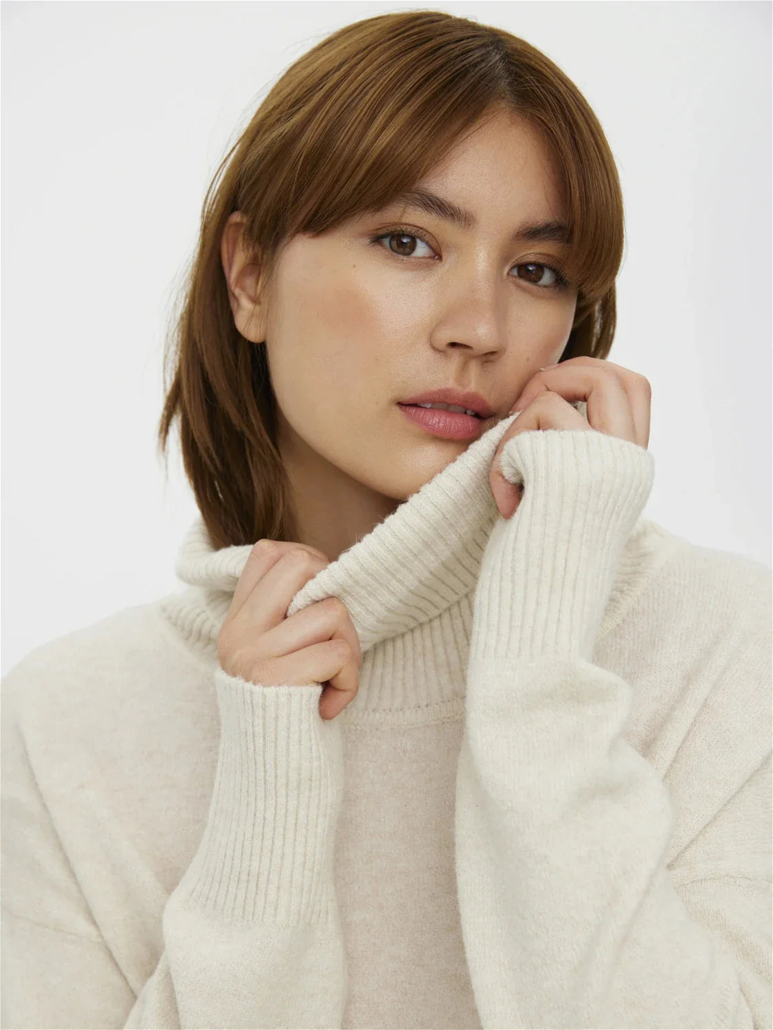 Cozy cream oversized sweater with ribbed turtleneck and effortless minimalist cold-weather style aesthetic.