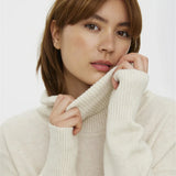 Cozy cream oversized sweater with ribbed turtleneck and effortless minimalist cold-weather style aesthetic.