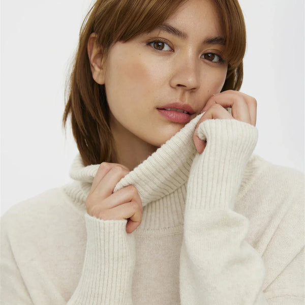 Cozy cream oversized sweater with ribbed turtleneck and effortless minimalist cold-weather style aesthetic.