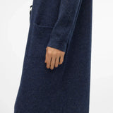 Sophisticated blue knit cardigan with long silhouette and elevated modern minimalist wardrobe styling.