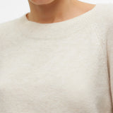Women’s neutral cream crew-neck sweater for versatile casual outfits with jeans, trousers, and skirts.