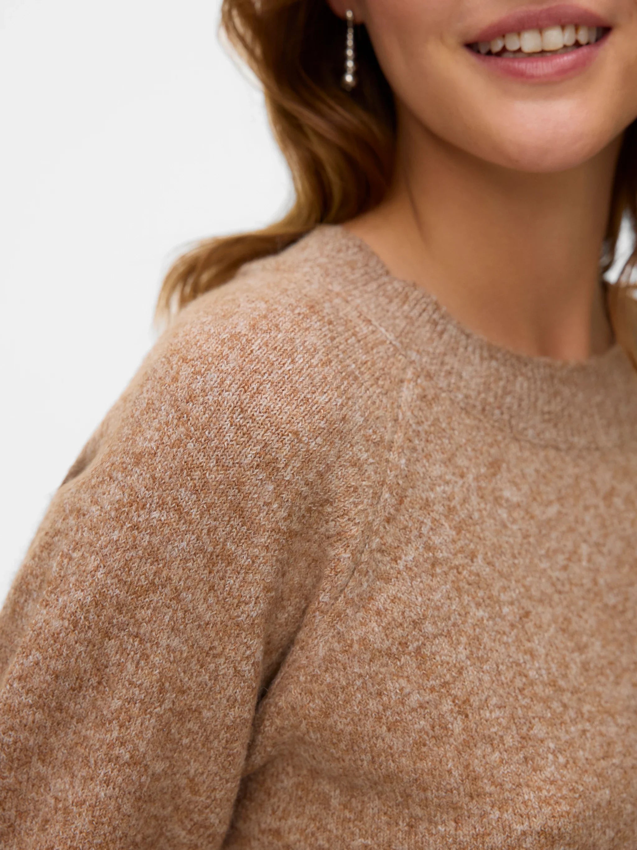 Close up of everyday luxury knitwear with warm earthy tones and elevated off-duty aesthetic