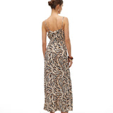 Resort-inspired maxi sundress with bold abstract animal print and flattering cinched waist detail.