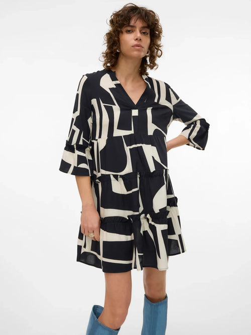 Modern black and ivory shift dress featuring artistic print, layered silhouette, and relaxed fit for casual luxe fashion.