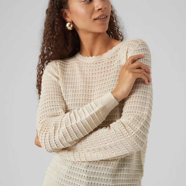 Chic cream long sleeve sweater with textured ribbed knit and feminine fitted style for versatile everyday fashion.