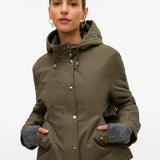 Olive green hooded utility coat for women with relaxed fit and functional pockets for casual travel and transitional weather.