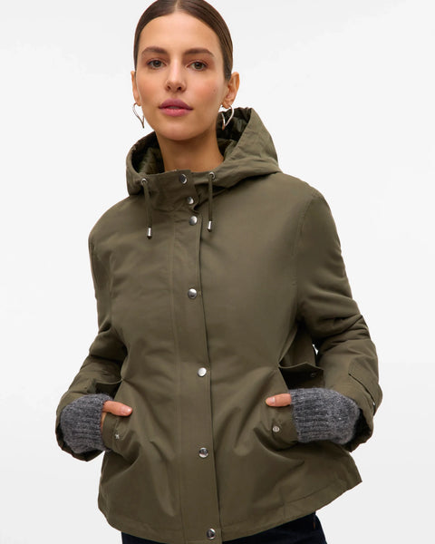 Olive green hooded utility coat for women with relaxed fit and functional pockets for casual travel and transitional weather.