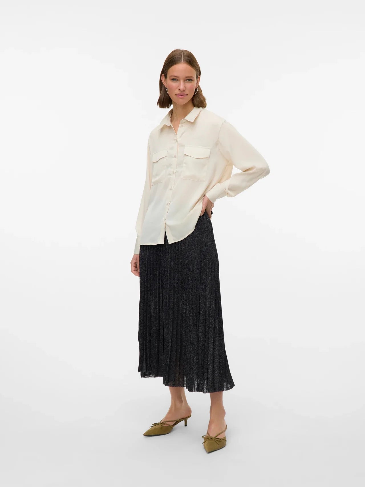 Women’s oversized ivory shirt featuring long sleeves, button front, and relaxed silhouette for effortless layering.