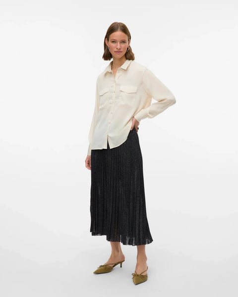Women’s oversized ivory shirt featuring long sleeves, button front, and relaxed silhouette for effortless layering.
